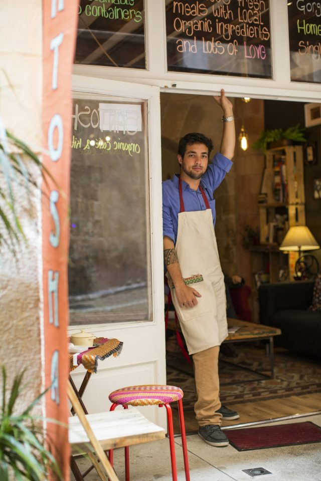 Restaurantbesitzer steht am Eingang des Cafés, Palma de Mallorca im Vierel Pere Garau